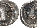 a close up of a coin with a face on it