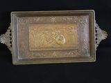 a gold plate with a picture on it on a black background