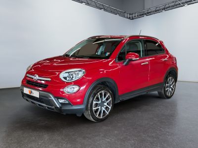the red fiat suv is parked in a large room