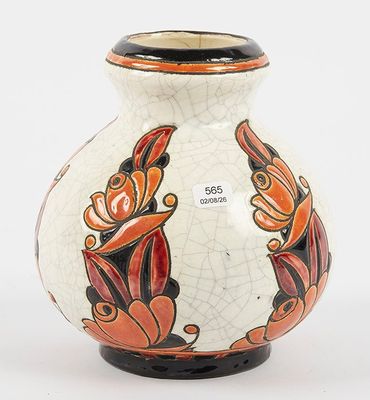 a white vase with orange and black designs on it