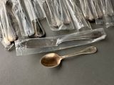 a lot of spoons and silverware in the bag