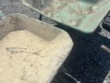 two wheelbarrows sitting next to each other on the ground