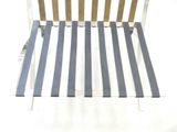 a white and blue striped chair sitting on a white surface