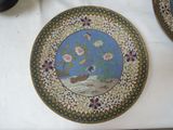 a plate with a picture of a bird and flowers on it