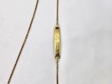 a close up of a gold necklace with a chain attached to it