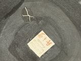 a black hat with a tag on it sitting on a table