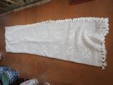 a large white crochet hanging on the wall
