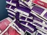 a pile of bags of white and purple material