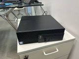 a computer on top of a filing cabinet in an office