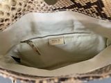 the inside of a snake skin purse with a zipper