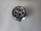 an image of a close up of a metal plug on a table