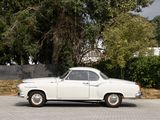 a white car that is parked on the side of the road