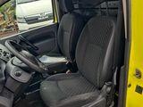 the interior of a yellow van with black seats and a steering wheel