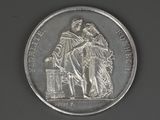 a silver coin with a picture of a man and a woman on it
