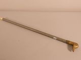a long stick with a handle on a white surface