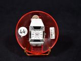 a watch in a red glass case on a black background