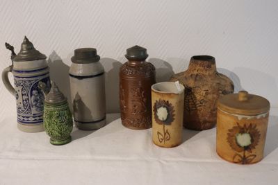 many different types of vases sitting on a table