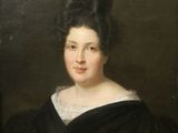 portrait of a woman in a black dress with a feathered headpiece