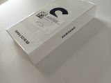 a white box on a table with a black logo on it