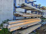 several pieces of wood are stacked on a rack in front of a building