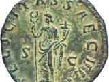 an ancient coin with a man holding a cross on it
