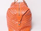 an orange goyard bag on a white background with a white background