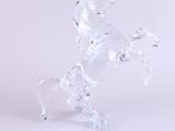 crystal figurine of a horse standing on its hind legs on a white surface