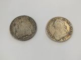 two silver coins, one with the head of a woman and one with a man ' s head