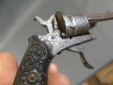a hand holding a gun that is in the palm of someone ' s hand