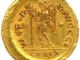 a close up of a gold coin with an image of an angel on it