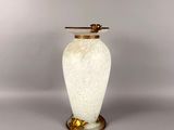 an image of a white vase with a gold handle