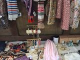 many different types of clothing hanging on a clothes rack