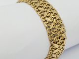 a close up of a gold bracelet on a napkin
