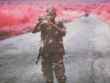 a man taking a picture of a red field with a camera