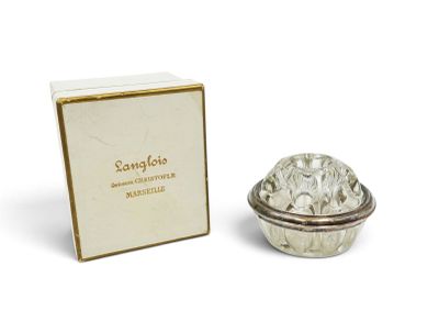 an image of a small silver bowl with a box in the background