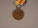 a medal with a ribbon around it on a table