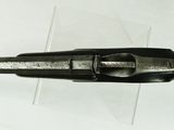 a close up of a gun on a white surface