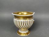 an image of a white and gold vase sitting on a table