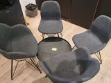 three chairs and a table in a room with wood flooring