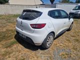 a small white car parked in the grass