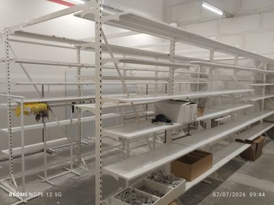 many shelves in the warehouse with boxes on them