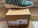 someone is wearing a pair of shoes that are on top of a box
