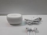 two ear buds and a charger sitting on a table