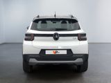 the rear end of a white car in a white room