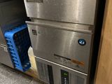 a stainless steel dishwasher in the middle of a kitchen