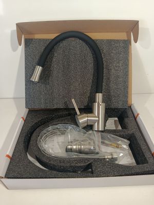 a box with a faucet and a hose in it
