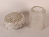 two pieces of glass sitting next to each other on a white surface