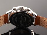 a close up of a watch on a black surface