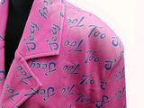 pink jacket with blue numbers and numbers on it on a mannequin