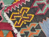 several different colored rugs are stacked on top of each other